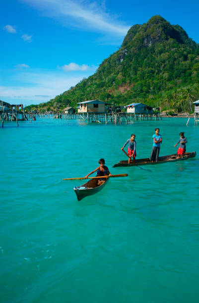 Borneo Sea Gypsy. Semporna, Malaysia -  April 26, 2016: A children of Sea Bajau from Bohey Dulang, Semporna, Sabah is always welcome the visitors and photographers. Please do bring sweets if you decided to visit them in the near future and that could bring them a little shied of happiness to their discreet of lifestyles。 mabul island stock pictures, royalty-free photos & images