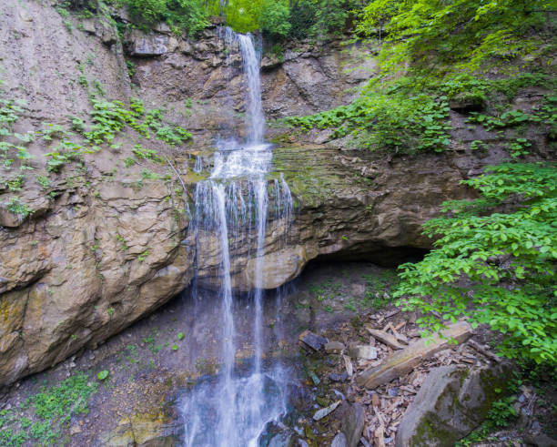 istock Stream mountain waterfall cascading from the cliff. Drone photo. 815218176