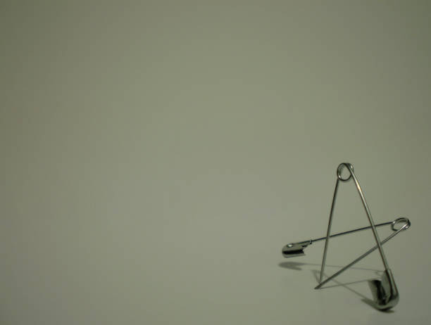 istock Safety pins angled to form a star 815218710