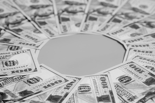 Hundred dollar US bills spread in a circle