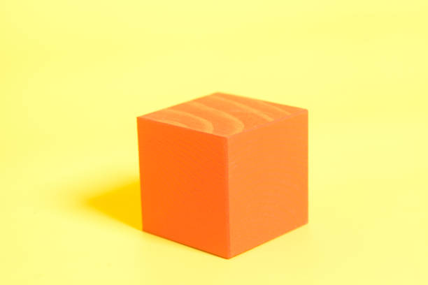 istock Red wooden cube on yellow background 815229480
