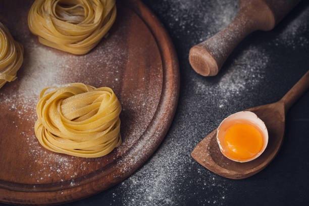 istock Raw homemade pasta with flour and spices on the rustic background. 815240148