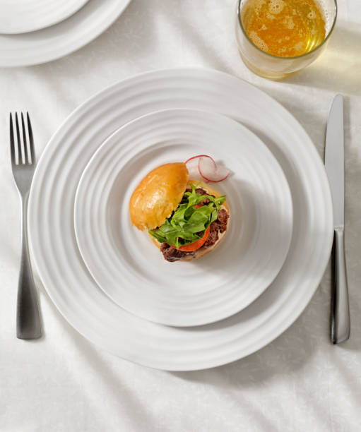 Gourmet Mini Burger with a Beer Sampler Gourmet Mini Burger with Tomatoes, Arugula and a Spicy Aioli Sauce appetizer plate stock pictures, royalty-free photos & images