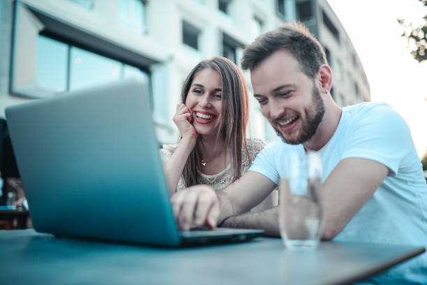 istock Young Couple Making Video Conference and Laughing in Coffee Bar 815259510