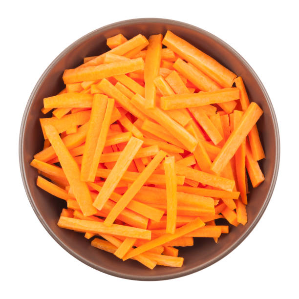 schüssel klein geschnittene möhren - carrot isolated white carotene stock-fotos und bilder