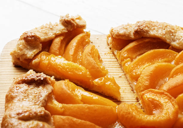 istock Homemade biscuit pie with peaches on white wooden table. 815270754