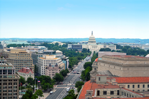 Aerial photo of downtown Washington D.C. along Pennsylvania Avenue including Capitol Hill in background.