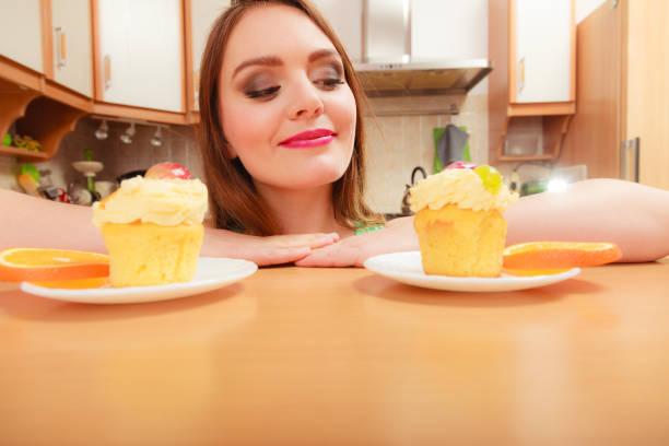 istock Woman looking at delicious sweet cake. Gluttony. 815277008