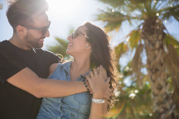 istock Young happy lovers cuddling together in sun light 815282056
