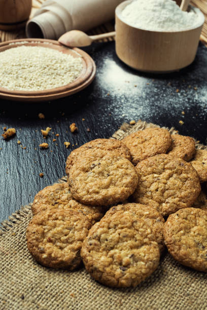 istock Biscuit sweet cookie background. Domestic stacked butter biscuit pattern concept,close up macro.Homemade cookies on wooden table.Cereal biscuits with the sesame,peanuts,sunflower and amaranth. 815287468