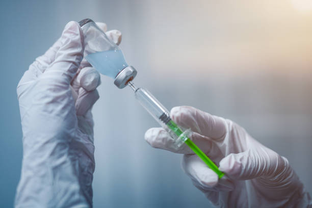istock Syringe, medical injection in hand. Vaccination equipment. 815292294
