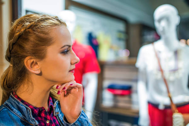 istock Shopping woman looking at a window 815292334