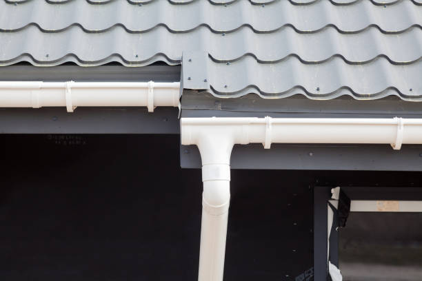 istock SIP panel house construction. New gray metal tile roof with white rain gutter 815325480