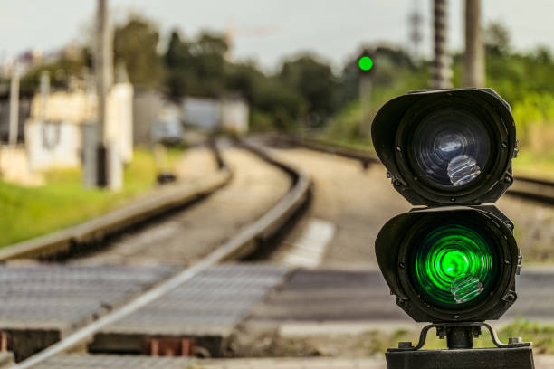 Routing traffic light with a green signal on railway. Railway crossing with semaphore. Permissive Motion. Limited depth of field. stock photo