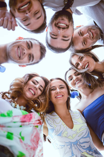 istock Group of Smiling Friends Creating Circle and Looking Down 815339394