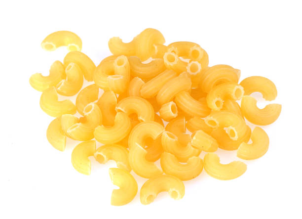 istock Closeup of dry elbow macaroni pasta. Isolated image 815344308