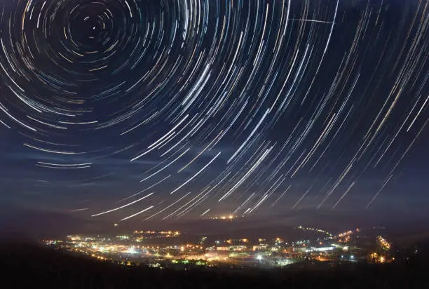 A picture of star tracks over mountain town