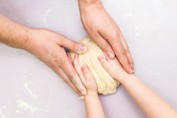 istock Children and dad hands make a dough 815347418