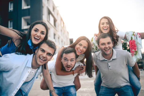 istock Young Smiling Couples Having Fun in City with Piggyback Ride 815349608