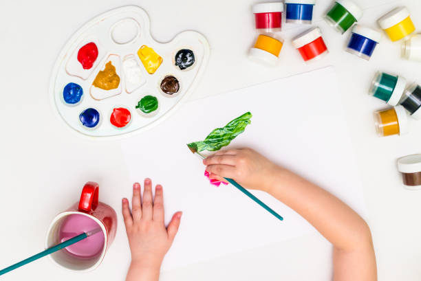 istock Child painting a flower 815349660