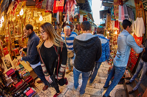 Jerusalem - 04.04.2017: Tourists walk trough the market in the old city of Jerusalem