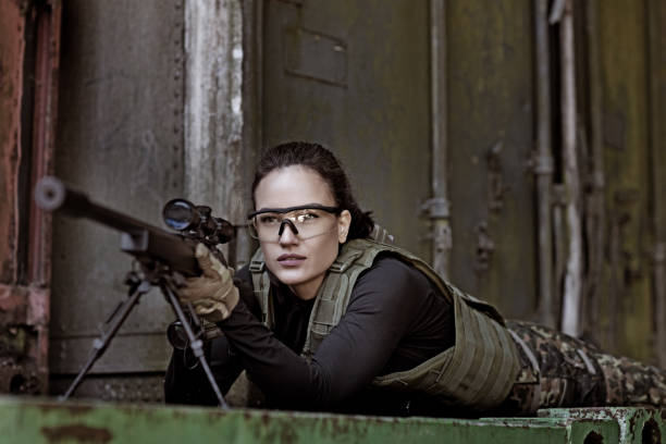 Lone brunette female soldier in outdoor setting