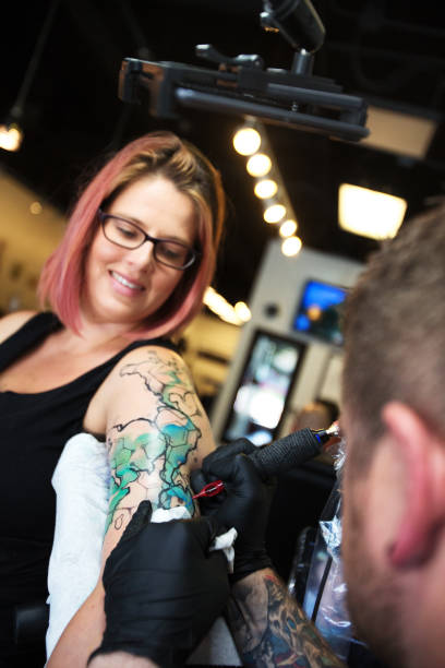 istock Tattoo Artist and Female Customer 815365396
