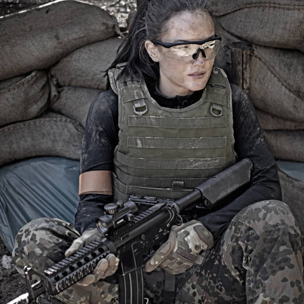 istock Lone brunette female soldier in outdoor setting 815367632