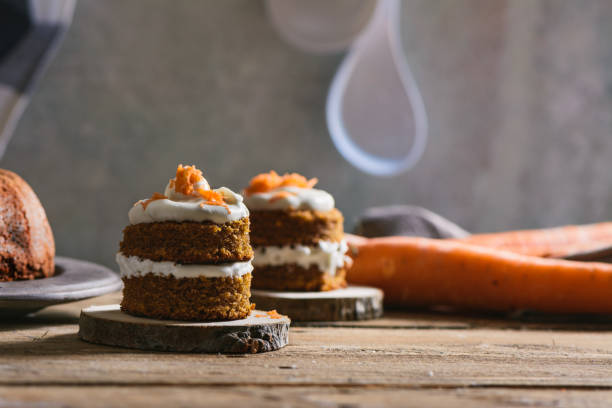istock Mini carrot cake, stuffed with cream cheese, on rustic wood plate 815381602
