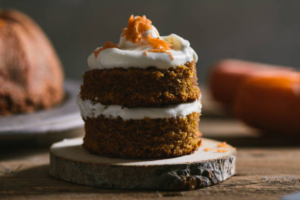istock Mini carrot cake, stuffed with cream cheese, on rustic wood plate 815381604