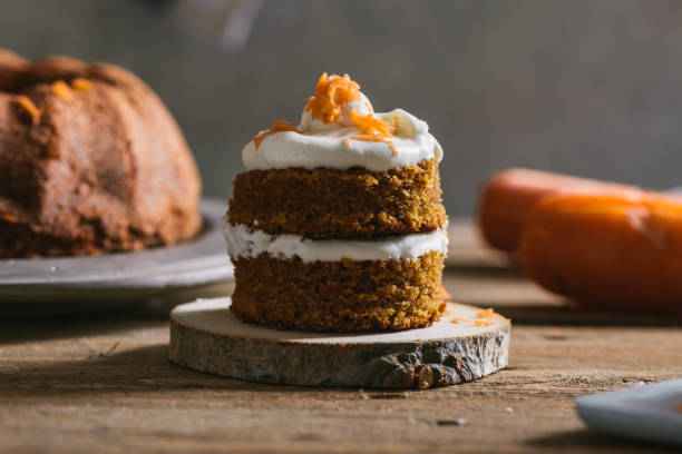 istock Mini carrot cake, stuffed with cream cheese, on rustic wood plate 815381652