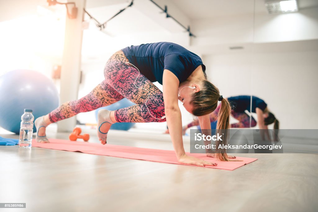 Young Athlete Female in Plank Pose doing Running Abs Exercising Stock Photo