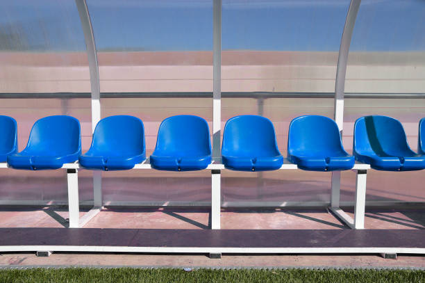istock bench with red plastic seats for players at the stadium 815398496