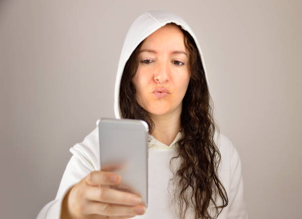 istock sending a kiss with phone 815398810
