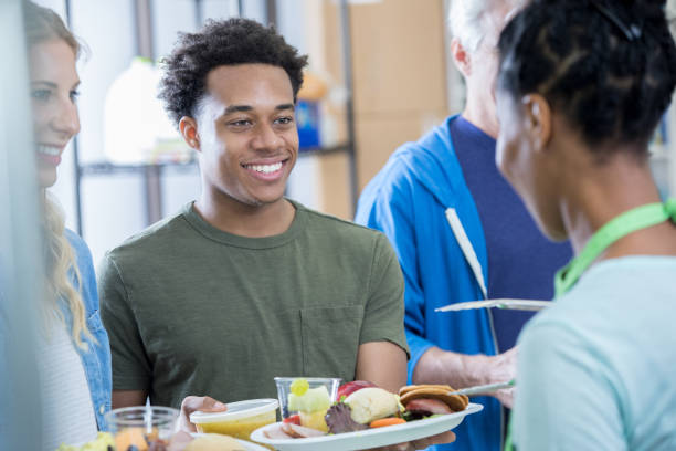 istock Couple receive a meal at soup kitchen 815401436