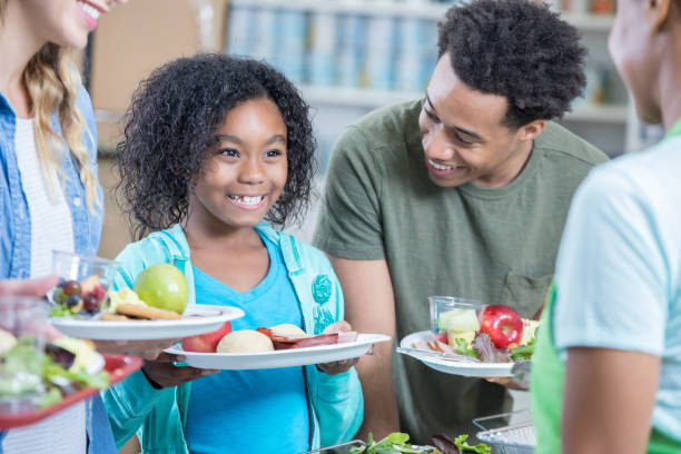 istock Happy young family receive meal at soup kitchen 815401454