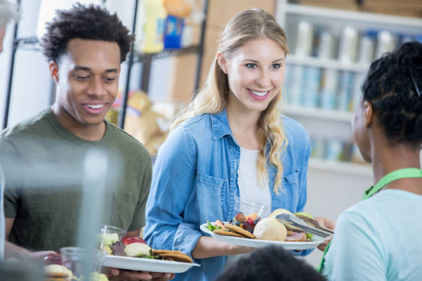 istock Volunteers serve meal at soup kitchen 815401456