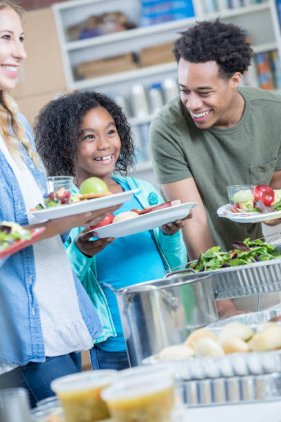 istock Happy family receive a meal at soup kitchen 815401460