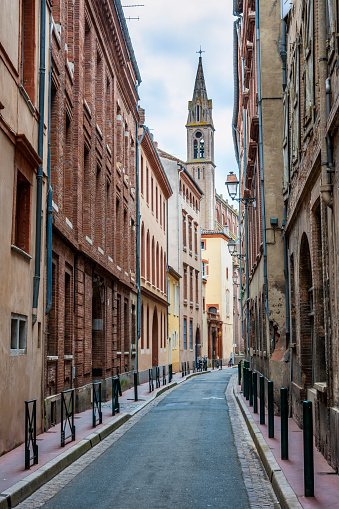 Narrow street  in old center of Toulouse, France.