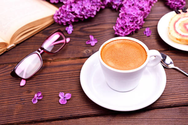 istock cup of espresso, behind an open book 815406378