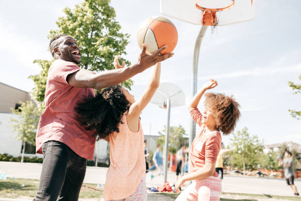 istock Father playing basketball with daughters 815417484