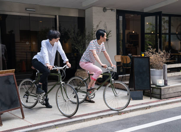 istock Young couple riding bicycles in an urban setting 815422764