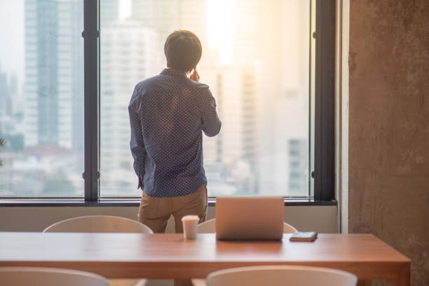 istock Young Asian man talking business on his smart phone 815425720