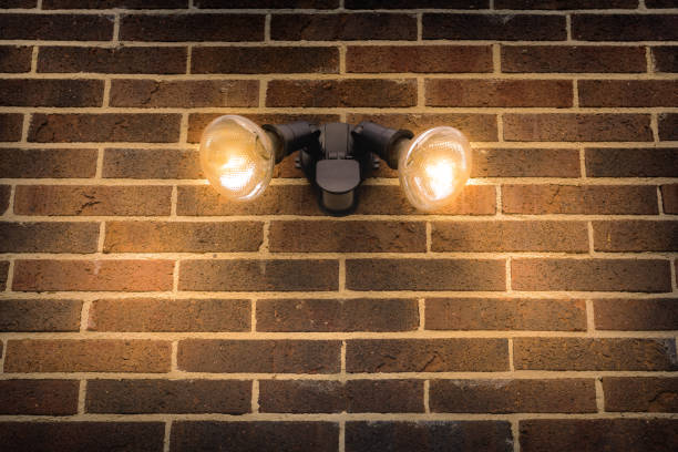 flood light on external brick wall daytime look up - motion sensor imagens e fotografias de stock