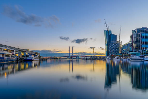 istock Harbour view with modern buildings and reflections at sunset, in Dockland, Melbourne, Australia. 815433596