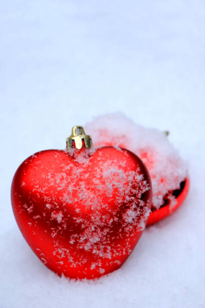 istock Red heart ornaments in snow 815445468