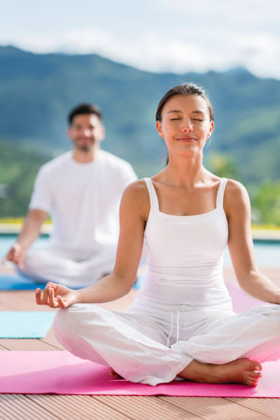 istock Peaceful couple doing yoga outdoors 815458538
