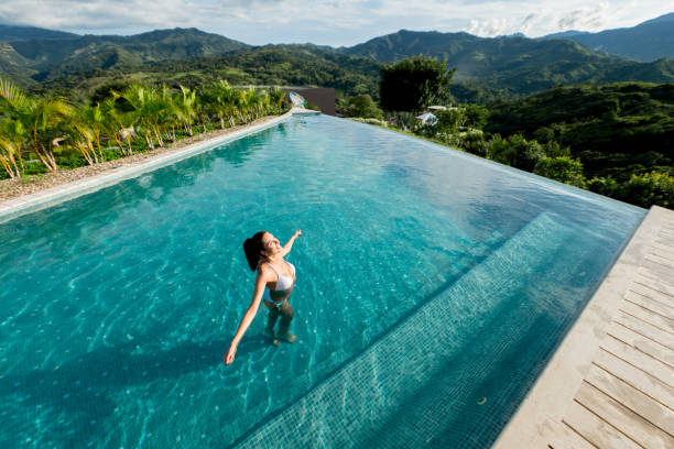 istock Woman on vacations relaxing in the swimming pool 815458556