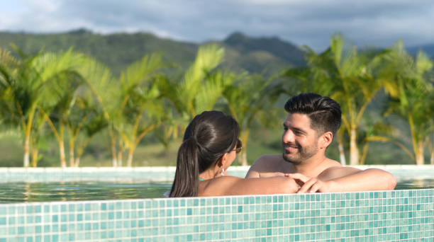 istock Couple in the pool enjoying a romantic getaway 815458594