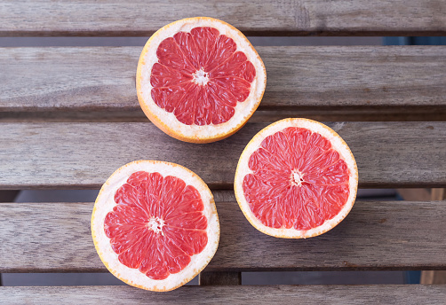 Red grapefruits on a wooden background